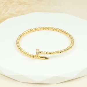 Brazalete de clavo dorado